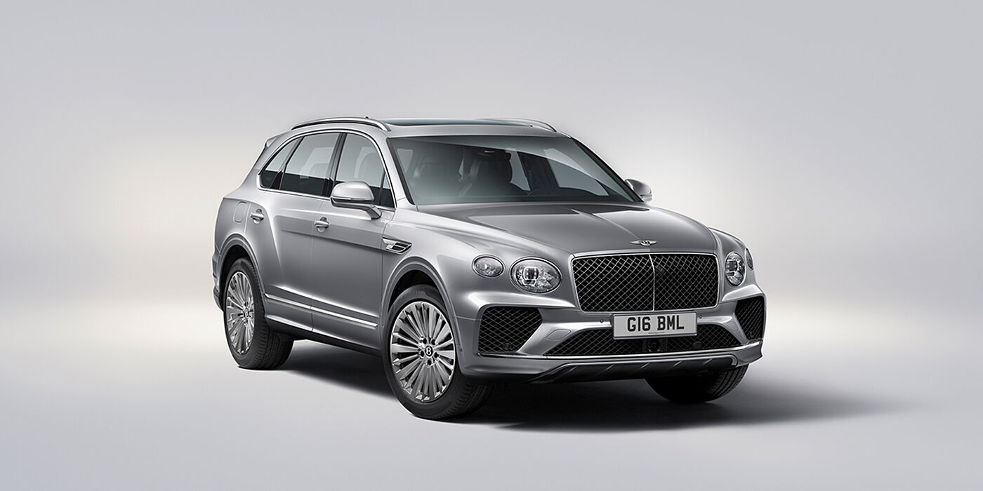 Emil Frey Exclusive Cars GmbH | Bentley München Bentley Bentayga luxury SUV front three quarter view in Moonbeam paint with matrix grille and 21″ 5 spoke painted wheels