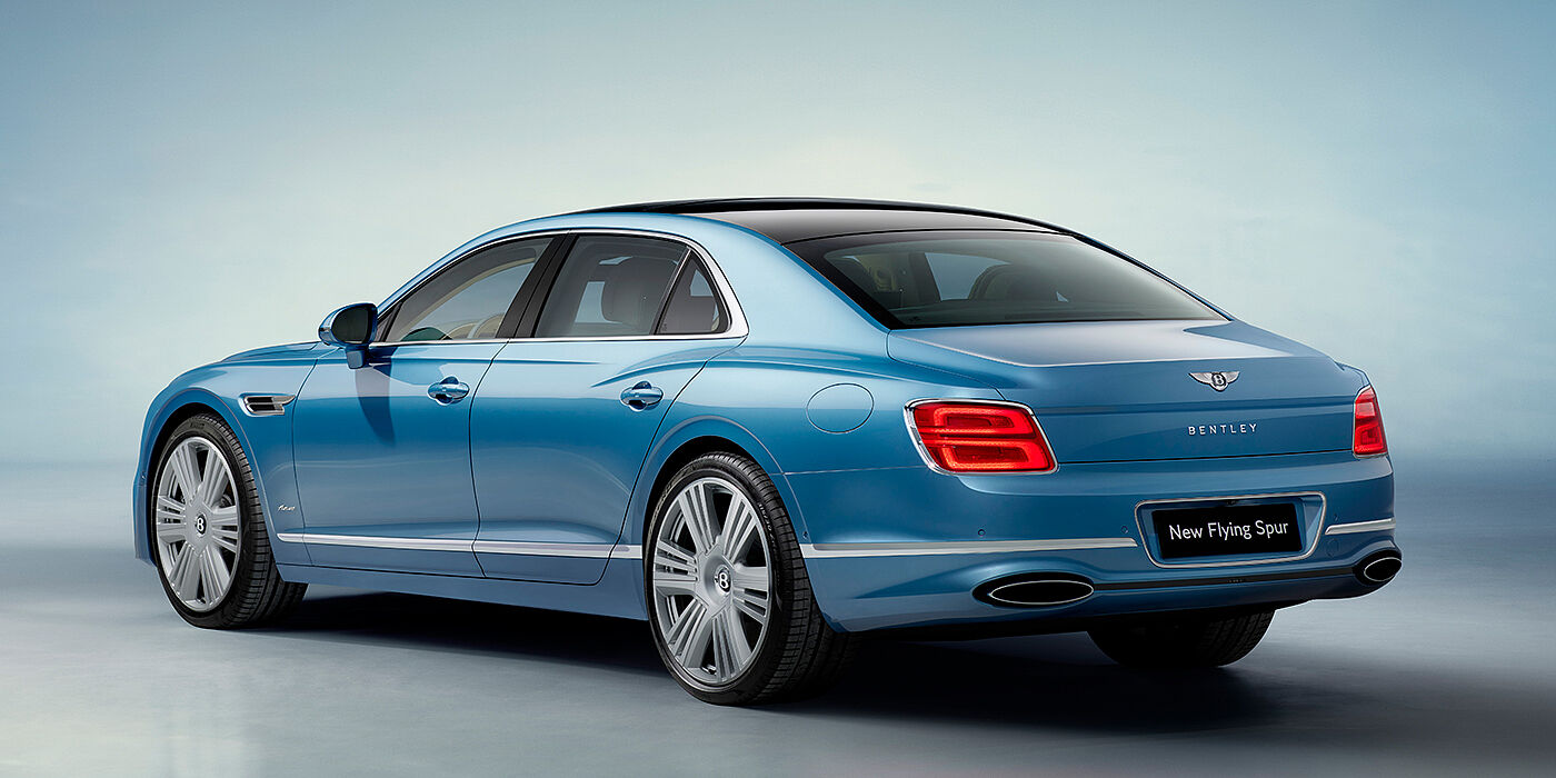 Emil Frey Exclusive Cars GmbH | Bentley München New Bentley Flying Spur Azure sedan rear view in Light windsor blue by Mulliner paint with 22 inch Azure wheels and chrome exterior details