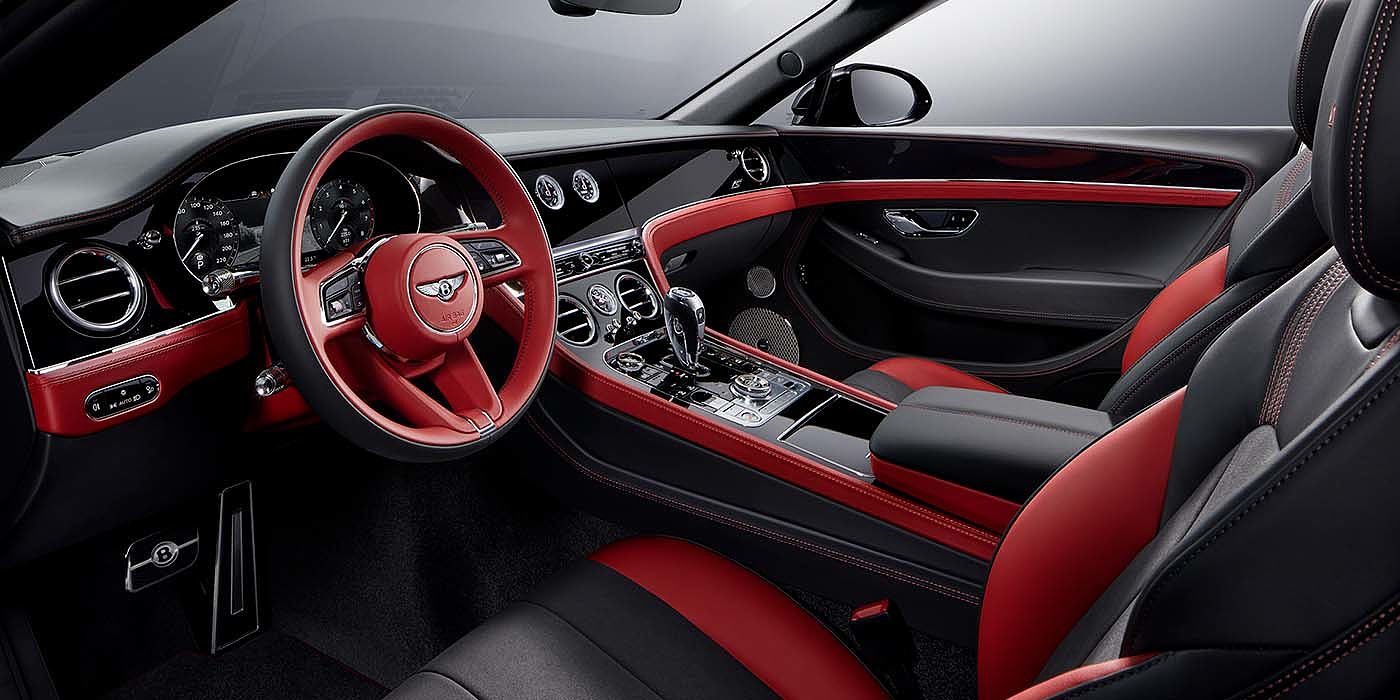 Emil Frey Exclusive Cars GmbH | Bentley München Bentley Continental GTC S convertible front interior in Beluga black and Hotspur red hide with high gloss carbon fibre veneer