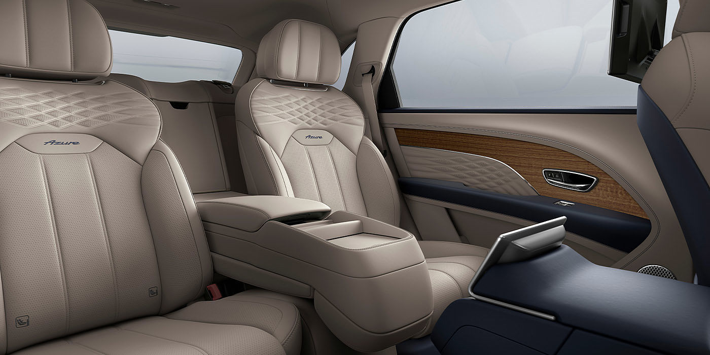 Emil Frey Exclusive Cars GmbH | Bentley München Bentley Bentayga EWB Azure interior view for rear passengers with Portland hide featuring Azure Emblem in Imperial Blue contrast stitch.