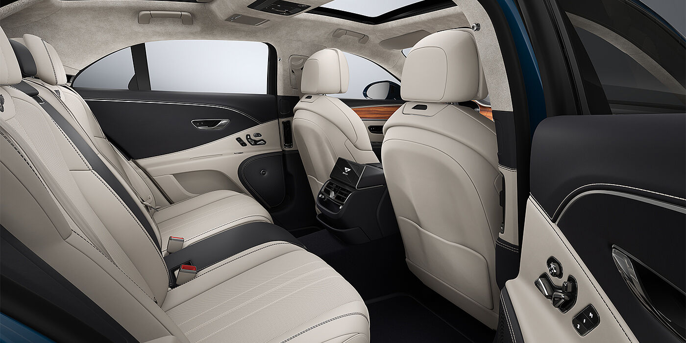 Emil Frey Exclusive Cars GmbH | Bentley München New Bentley Flying Spur sedan rear interior in Linen and Imperial Blue hides with Open Pore Koa veneer