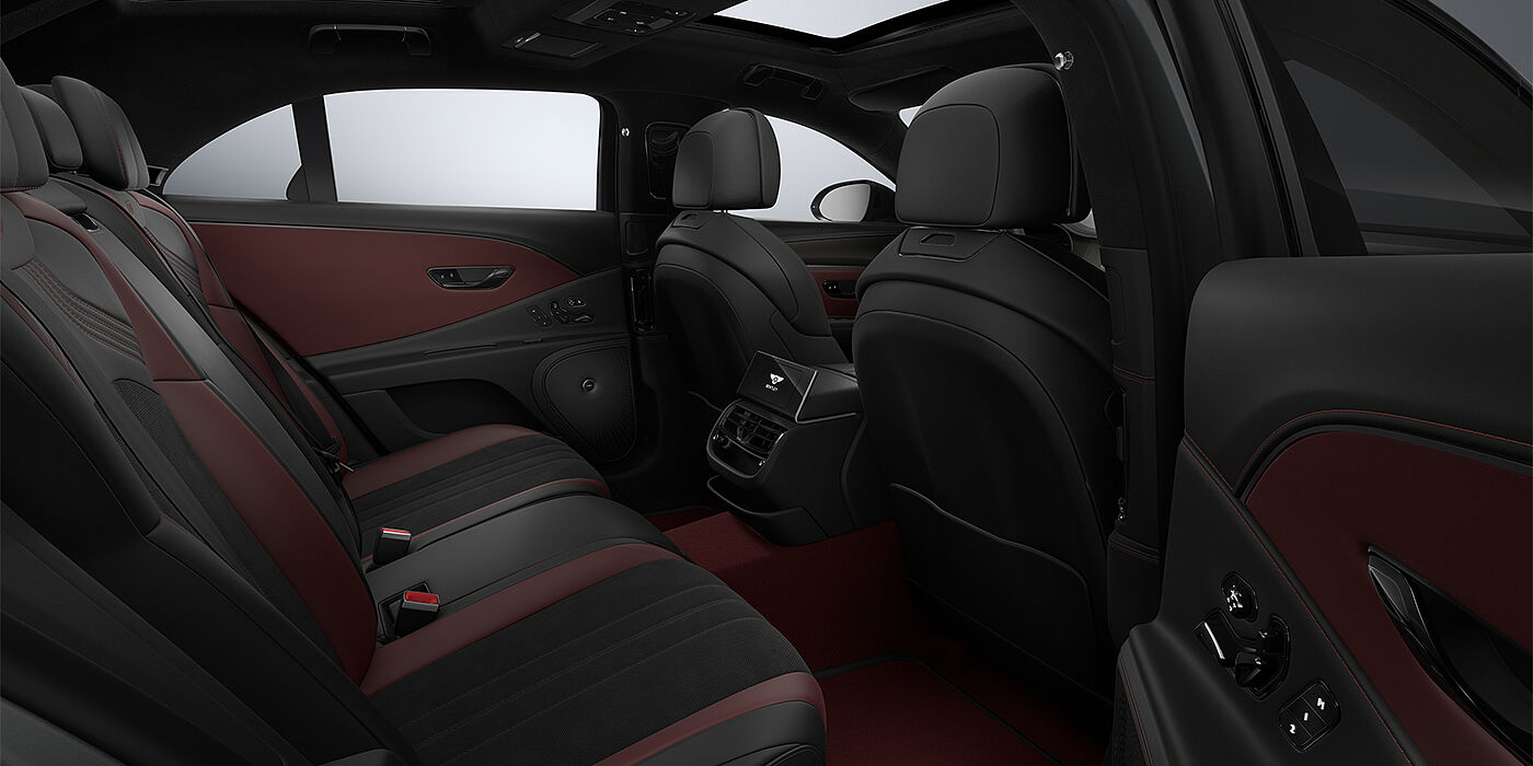 Emil Frey Exclusive Cars GmbH | Bentley München New Bentley Flying Spur S sedan rear interior in Cricket Ball red  and Beluga black hides with High Gloss Carbon Fibre veneer