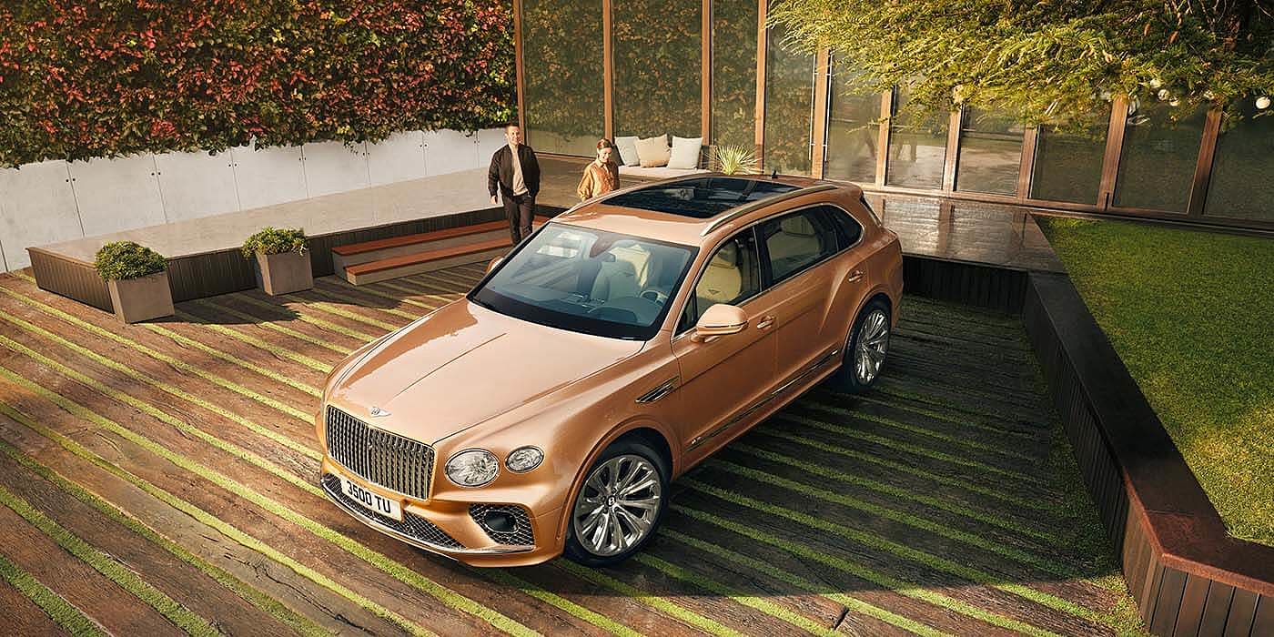 Emil Frey Exclusive Cars GmbH | Bentley München Bentley Bentayga EWB Azure SUV in Rose Gold paint overhead