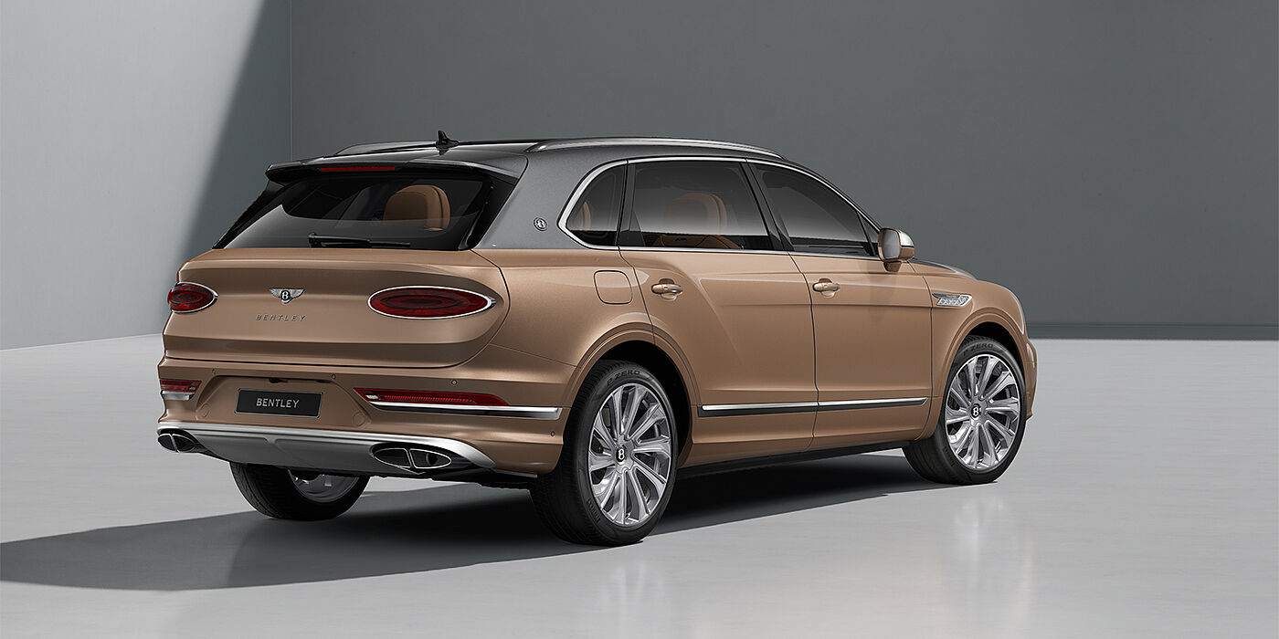 Emil Frey Exclusive Cars GmbH | Bentley München Bentley Bentayga EWB Mulliner SUV in Magnetic and Rose Gold paint and 22" Mulliner wheels rear ¾