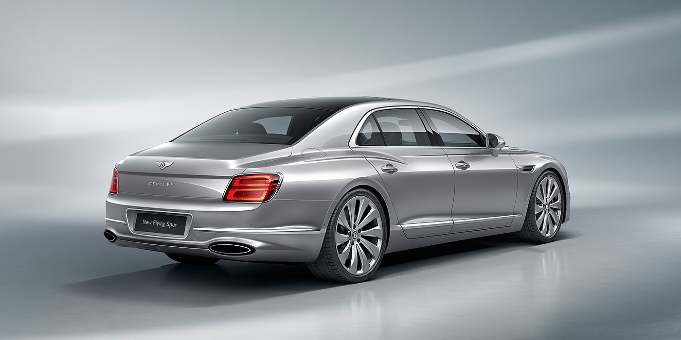 Emil Frey Exclusive Cars GmbH | Bentley München New Bentley Flying Spur sedan rear view in Silverlake paint with ten spoke wheels and chrome matrix grille