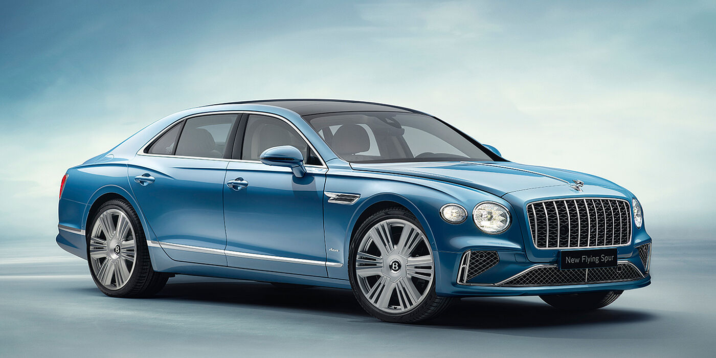 Emil Frey Exclusive Cars GmbH | Bentley München New Bentley Flying Spur Azure sedan front view in Light windsor blue by Mulliner paint with 22 inch Azure wheels and chrome exterior details