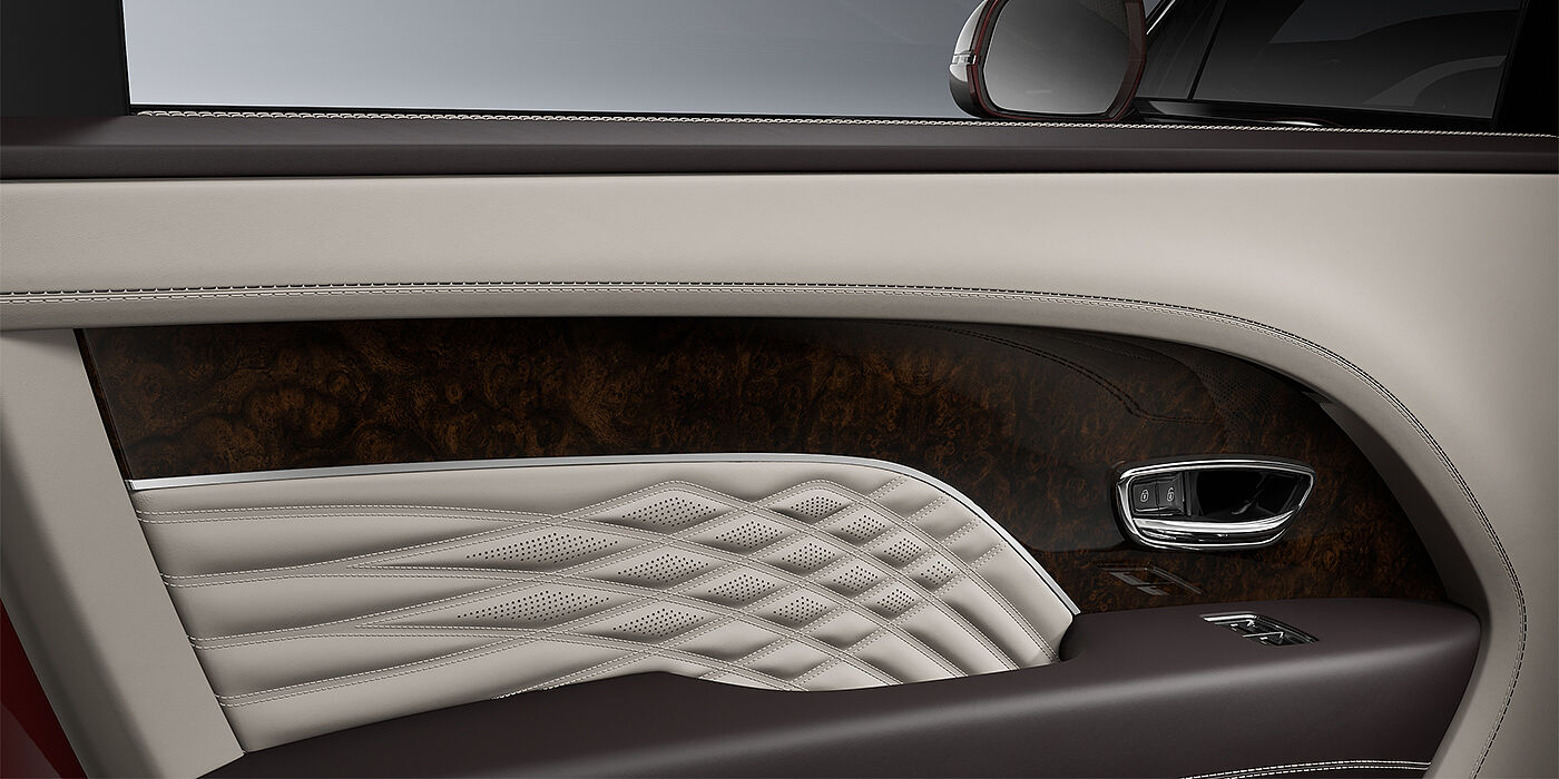 Emil Frey Exclusive Cars GmbH | Bentley München Bentley Bentayga EWB Azure SUV door interior detail in Linen and Burnt Oak hides with Dark Stained Burr Walnut veneer
