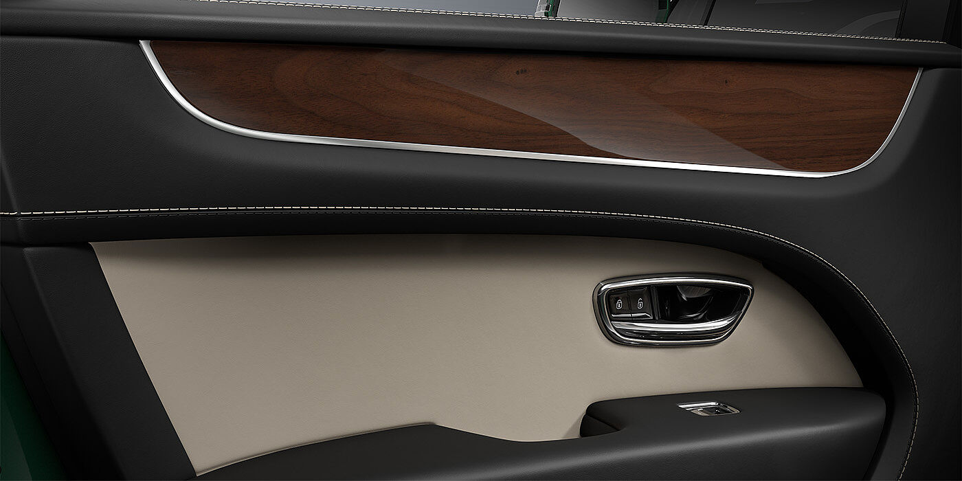 Emil Frey Exclusive Cars GmbH | Bentley München Bentley Bentayga SUV door interior detail in Portland and Beluga black hides with Crown Cut Walnut veneer