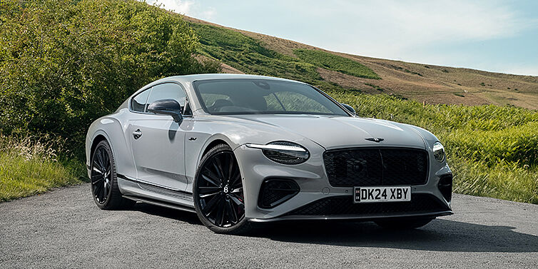 Emil Frey Exclusive Cars GmbH | Bentley München Bentley Continental GT front three quarter with Carbon Fibre Specification parked on road.
