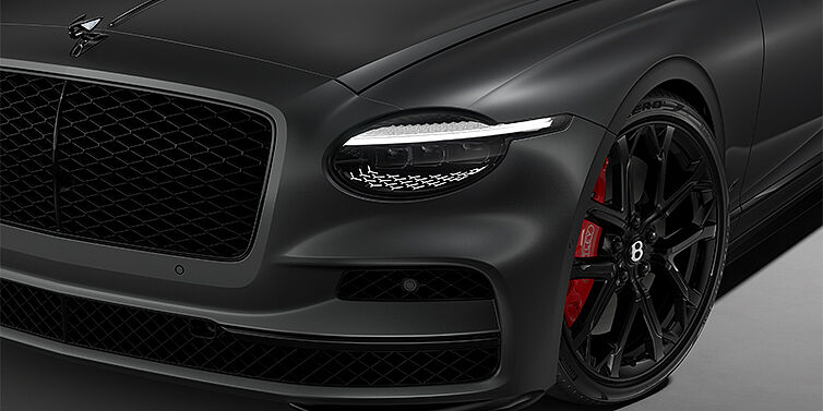 Emil Frey Exclusive Cars GmbH | Bentley München New Bentley Flying Spur S sedan head lamp against Anthracite Satin paint with  22" Sports wheel
