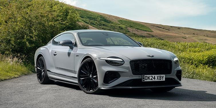 Emil Frey Exclusive Cars GmbH | Bentley München Bentley Continental GT front three quarter with Carbon Fibre Specification parked on road.