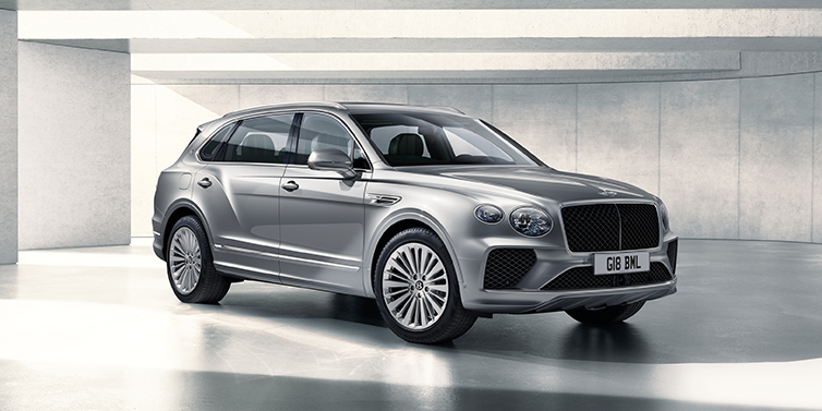 Emil Frey Exclusive Cars GmbH | Bentley München Bentley Bentayga Extended Wheelbase SUV front three quarter in Moonbeam paint with a grey background