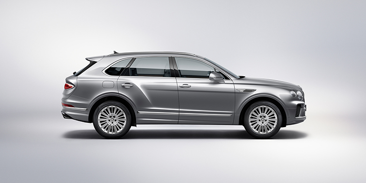 Emil Frey Exclusive Cars GmbH | Bentley München Bentley Bentayga SUV side profile in Moonbeam silver paint against white background featuring 21 inch 5 spoke wheels
