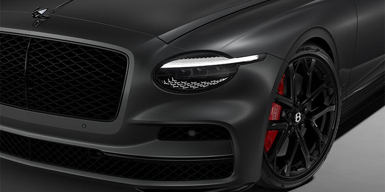 Emil Frey Exclusive Cars GmbH | Bentley München New Bentley Flying Spur S sedan head lamp against Anthracite Satin paint with  22" Sports wheel