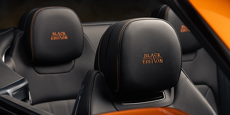 Emil Frey Exclusive Cars GmbH | Bentley München Bentley Continental GTC Black Edition convertible seat detail with Beluga black hide and Mandarin emblem stitching