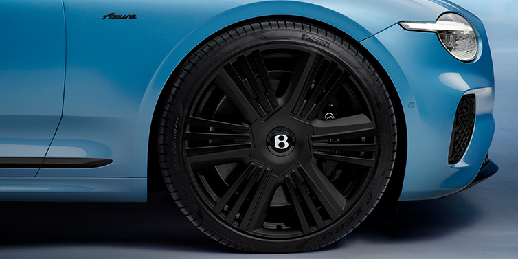Emil Frey Exclusive Cars GmbH | Bentley München New Bentley Continental GTC Azure convertible front wheel detail with 22 inch black ten spoke wheel and dark chrome details against Light Windsor blue paint