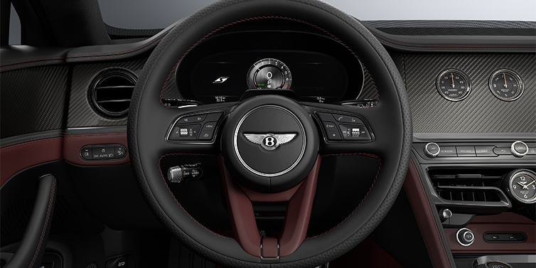 Emil Frey Exclusive Cars GmbH | Bentley München New Bentley Flying Spur S sedan steering wheel and dash in Cricket Ball red and Beluga black hides and High Gloss Carbon Fibre veneer